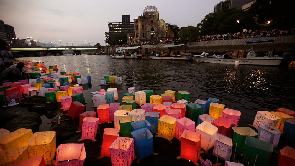 

Paper lanterns float along the Motoyasu River in front of the illuminated Atomic Bomb Dome in Hiroshima. (Photo: AP)