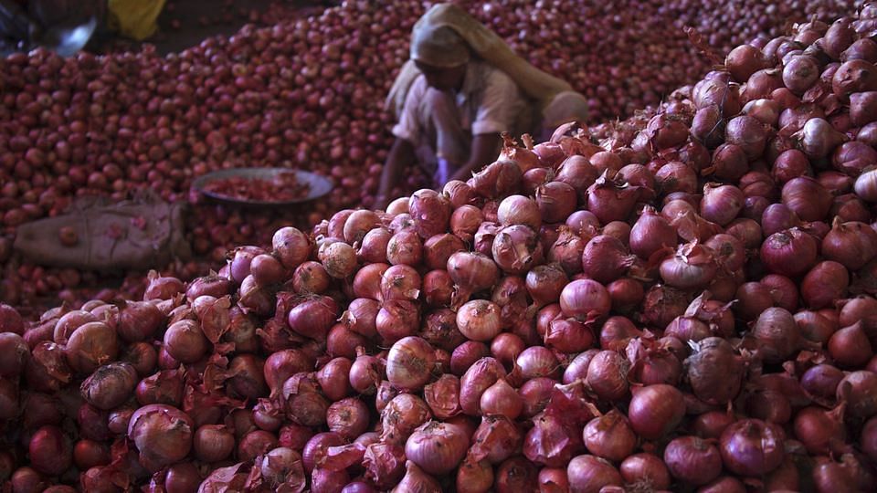 A worker sifts through piles of onions in Lasalgaon, Maharashta.&nbsp;(Photo: Reuters)