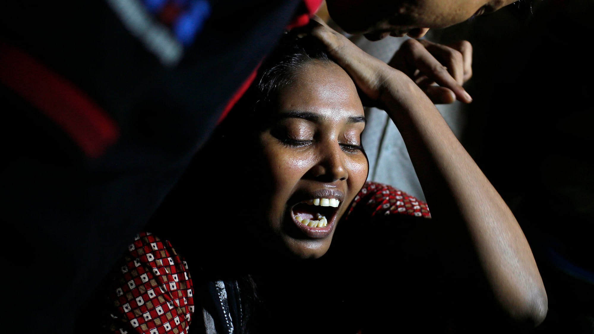 Ashamoni, wife of blogger Niloy Chowdhury, cries at her house in Dhaka on Friday. (Photo: AP)<a></a>