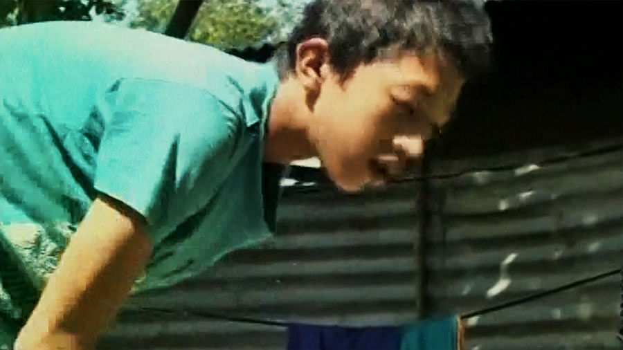 the 14-yr-old boy Konkham, who will address the world community at the 70th UN General Assembly in New york, taking care of household chores at his home in Imphal. (Photo Courtesy: ANI Screengrab)