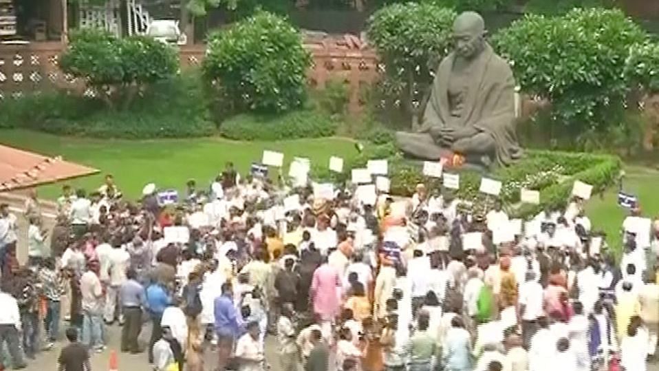 NDA members in front of the Gandhi statue near Parliament. (Photo: ANI)
