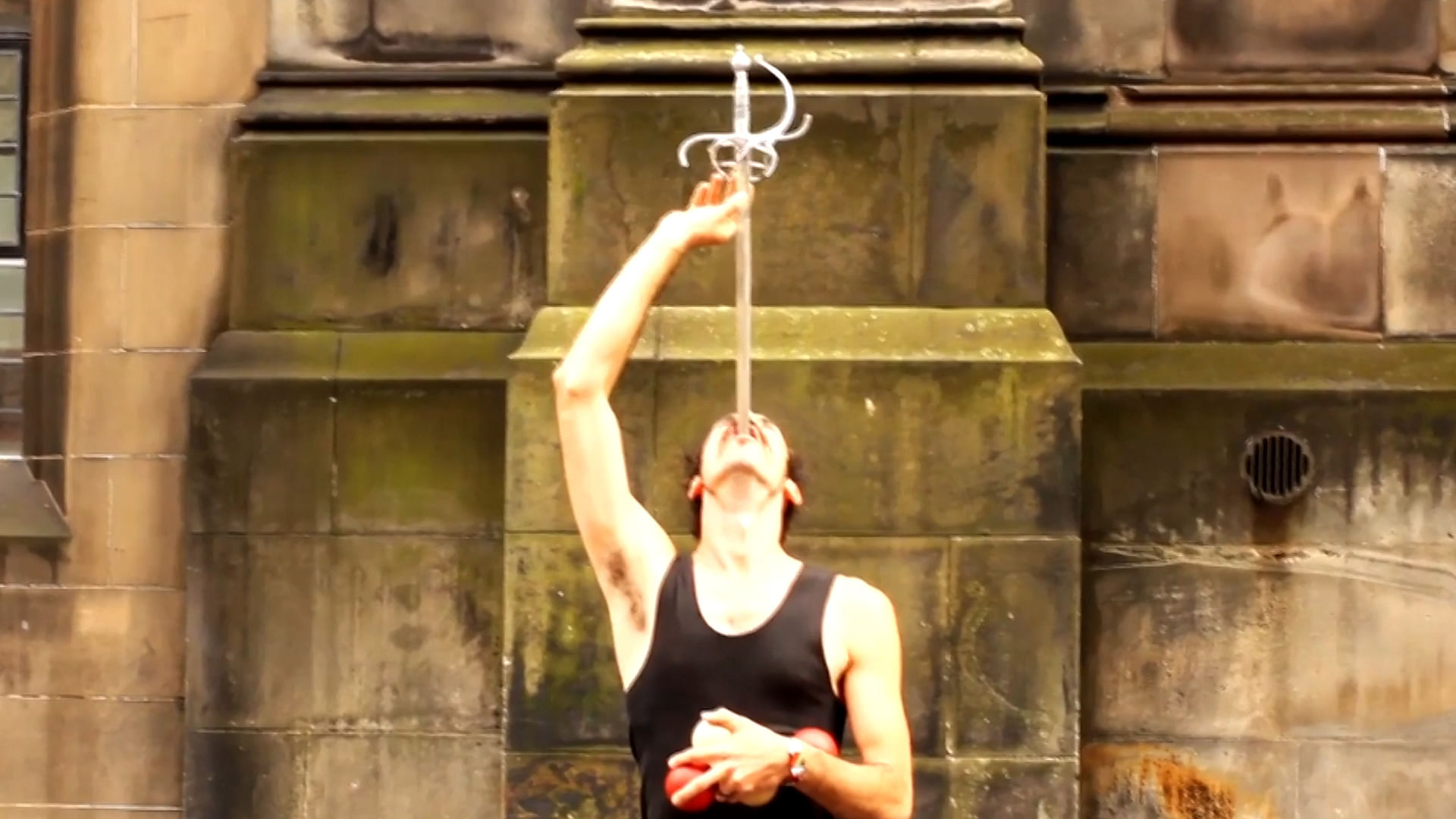 This man swallows a sword and juggled with balls. (Photo: AP screengrab)