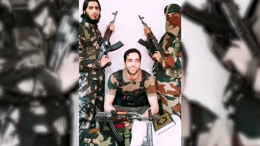 A still of Burhan Wani, 21-yr-old commander of the Hizb-Ul-Mujahideen with Saddam Padder on the left side while he sermonises the Kashmiri youth and the State Police. (Photo Courtesy: ANI Screengrab)