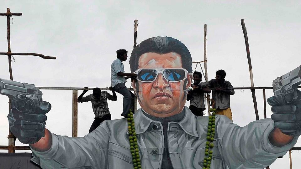 Fans pour milk over a cut out of Tamil superstar Rajinikanth from the film Enthiran. (Photo: Reuters)