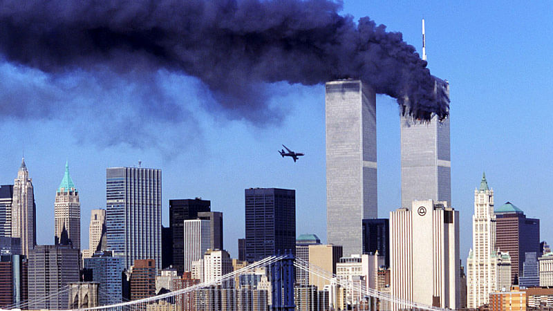 Hijacked United Airlines Flight 175 flies
towards the World Trade Center, as the north tower burns following an earlier attack.