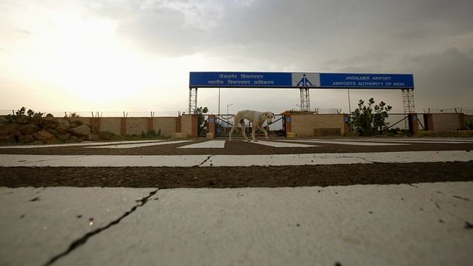 A dog walks past the main entrance of the Jaisalmer Airport. (Photo: Reuters)  