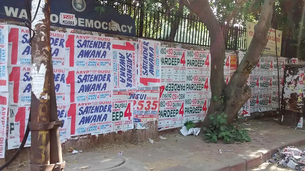Walls plastered by campaign bills for ABVP and NSUI candidates. (Photo: Neha Yadav/The Quint)