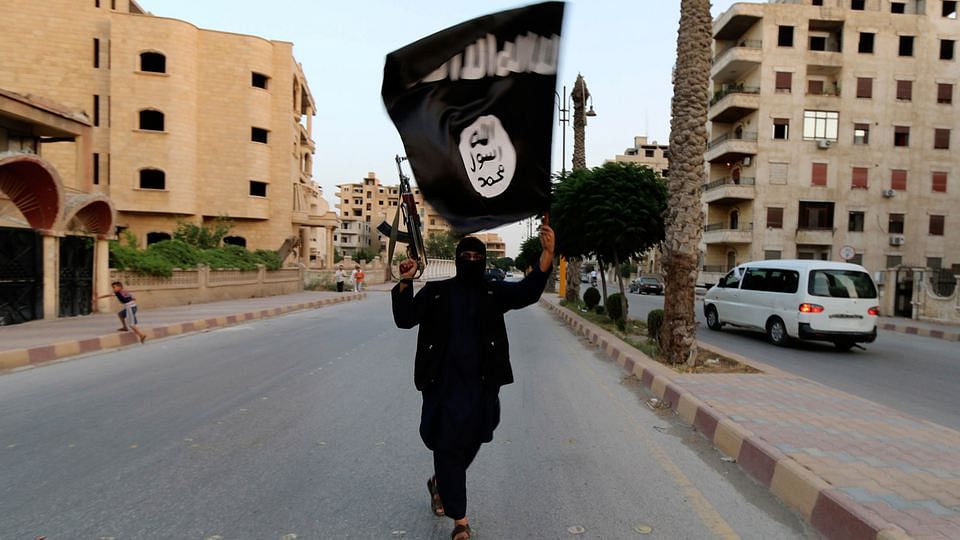 ISIS sympathiser waves the terror group’s flag. Image used for representational purposes.&nbsp;