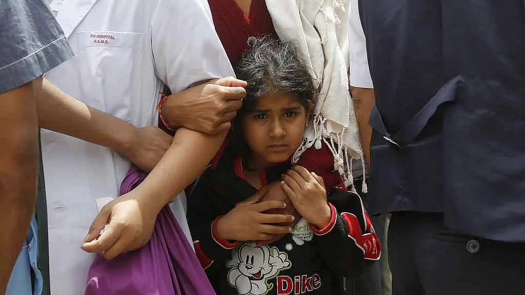 April 26, 2015: A girl holds her mother as they stand outside a hospital during a strong aftershock after an earthquake in Kathmandu, a day after the 7.9 magnitude earthquake struck Nepal. (Photo: Reuters)