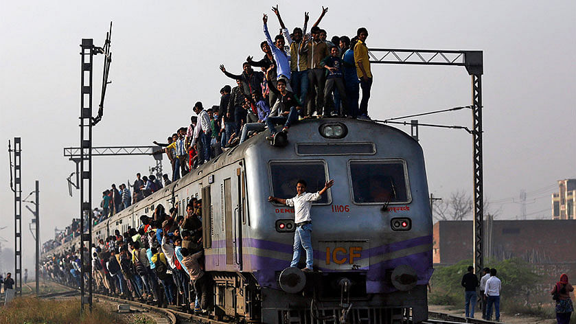 Passengers travel on an overcrowded train on the outskirts of New Delhi. (Photo: Reuters)