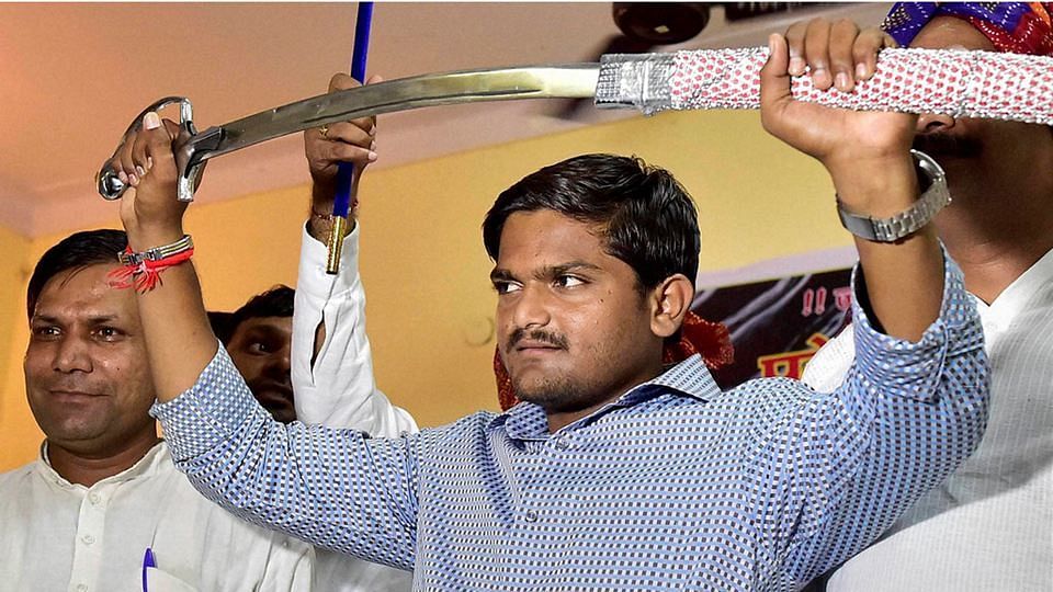 Hardik Patel, convener of the Patidar Anamat Andolan Samiti (PAAS), brandishes a sword presented to him at a function organised by Gujjars to honour him in New Delhi.&nbsp;