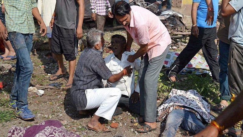 People in Jhabua helping the injured on the site of explosion. (Photo: PTI)