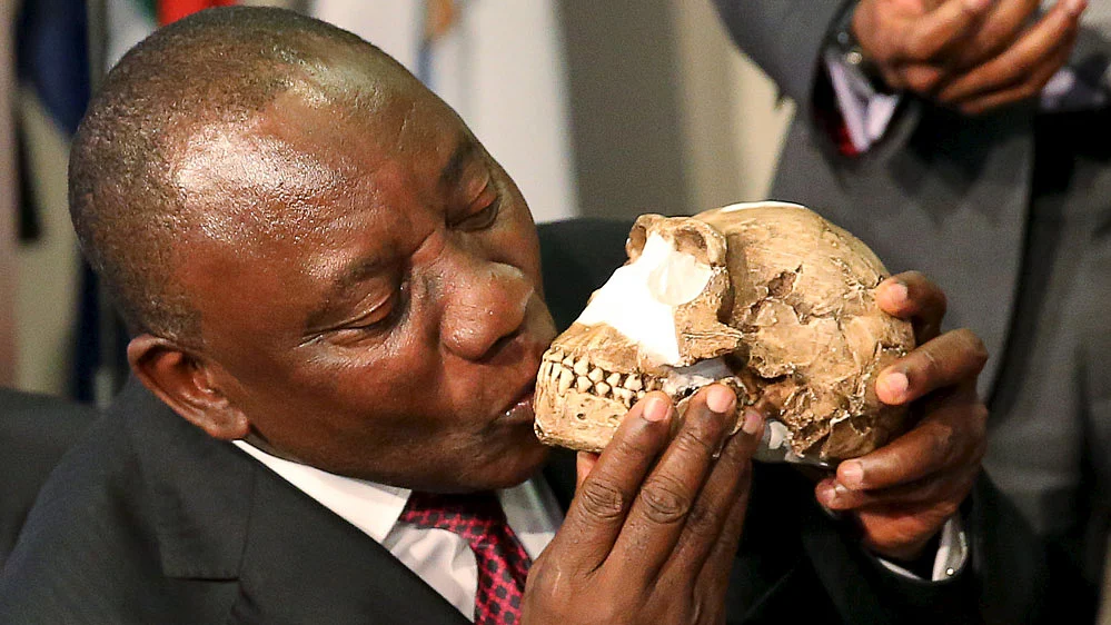 South Africa’s Deputy President Cyril Ramaphosa kisses a replica of the skull of a newly discovered ancient species, <i>Homo naledi</i>, who also appeared to bury their dead. (Photo: Reuters)
