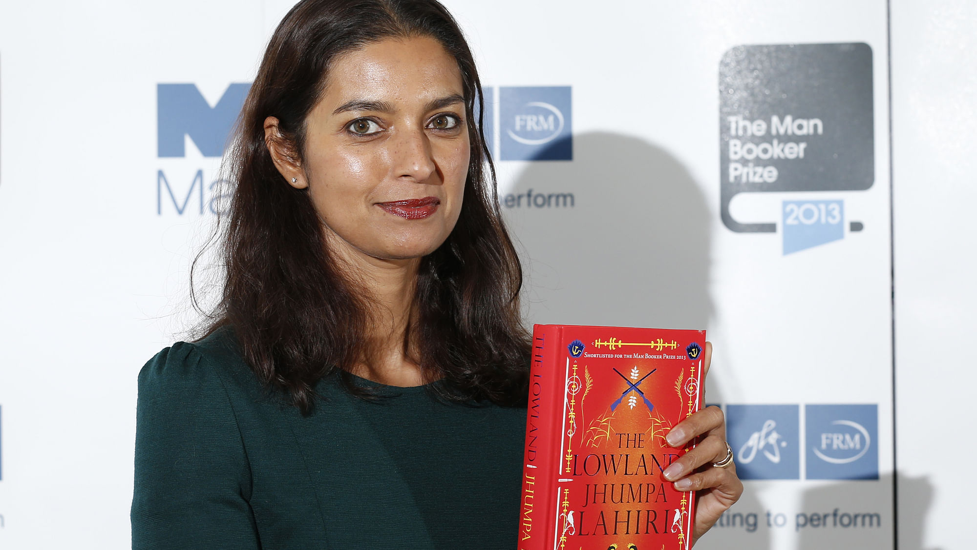 Jhumpa Lahiri poses with her book “The Lowland” at the Southbank Centre in London, October 13, 2013. (Photo: Reuters)