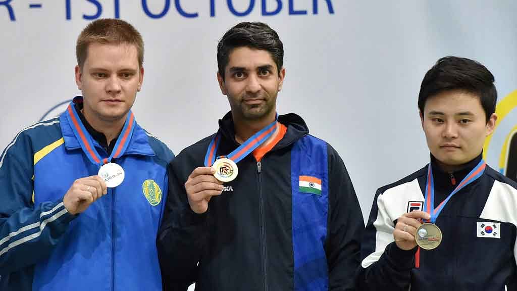 Abhinav Bindra with his gold medal, Silver medalist Yuriy Yurkov (KAZ) and bronze medalist Jaechul Yu (KOR) pose during the medal ceremony for the 10m Air Rifle event. (Photo: PTI)