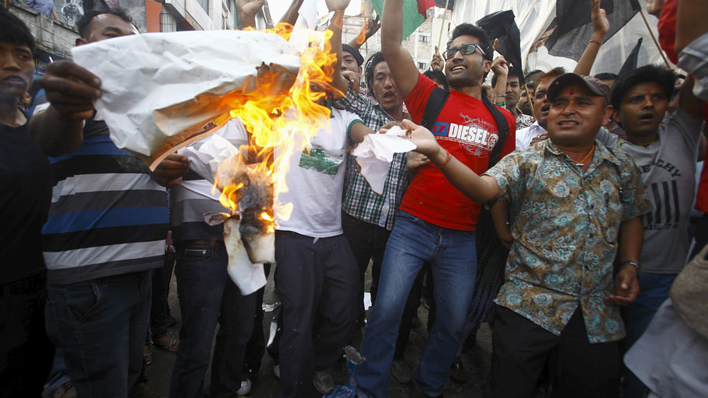 On September 21, supporters of opposition parties burnt papers symbolising Nepal’s first democratic Constitution during a protest in Kathmandu. (Photo: Reuters)