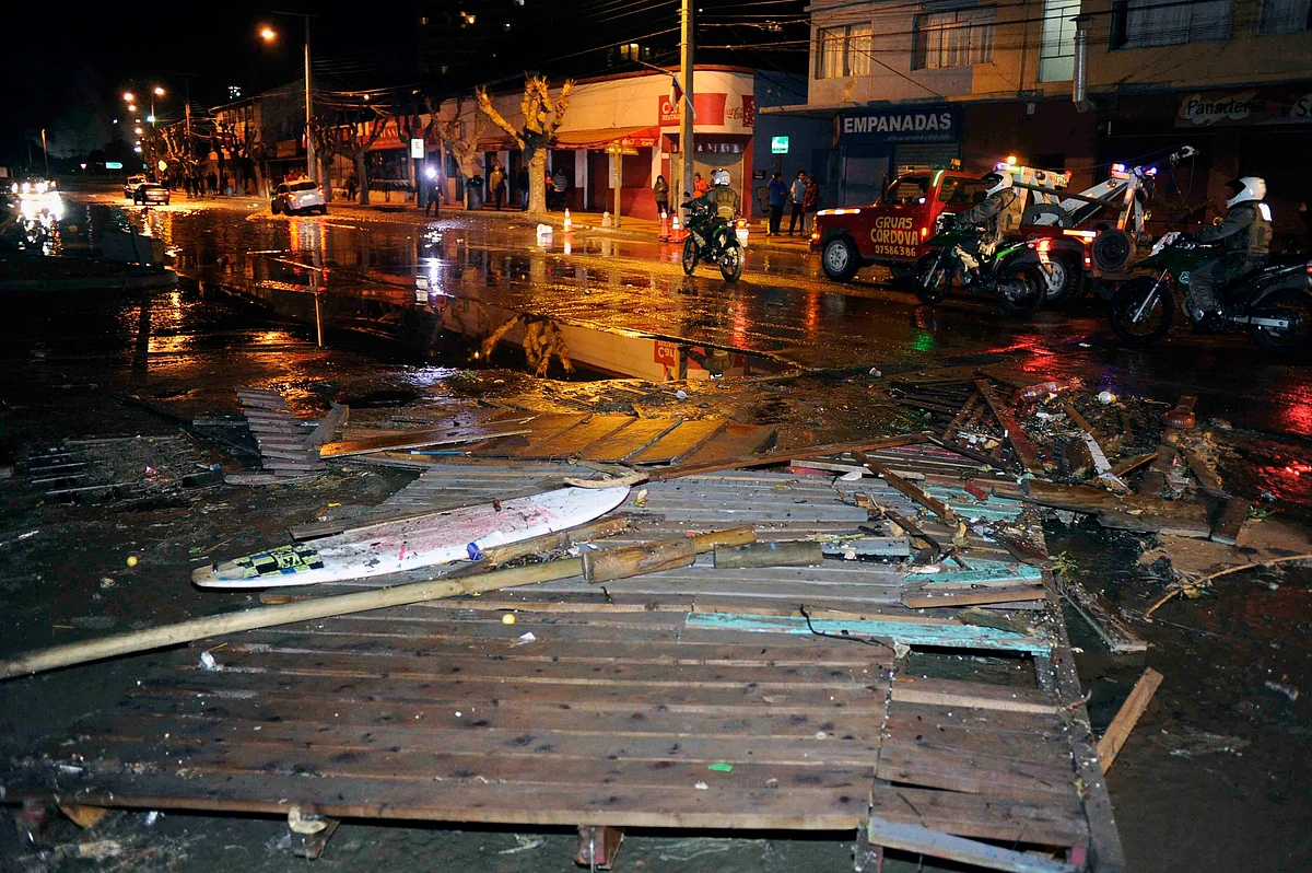 Police patrol a debris strewn street in Valparaiso, Chile, after a tsunami, caused by an earthquake hit the area, Wednesday. (Photo: AP)