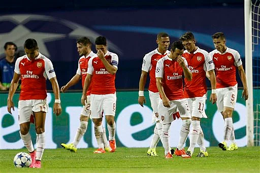 Arsenal players walk back to the half way line after Dinamo scored their 2nd goal during their Champions League Group F fixture. (Photo: AP)
