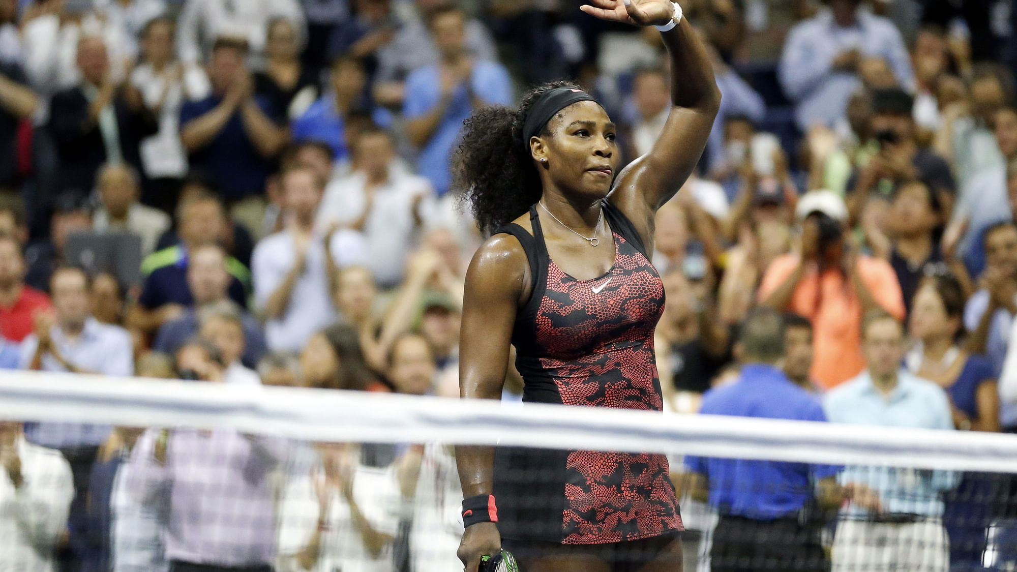 Serena Williams waves to the crowd after beating her sister Venus in the quarter-final of the US Open on Tuesday. (Photo: AP)