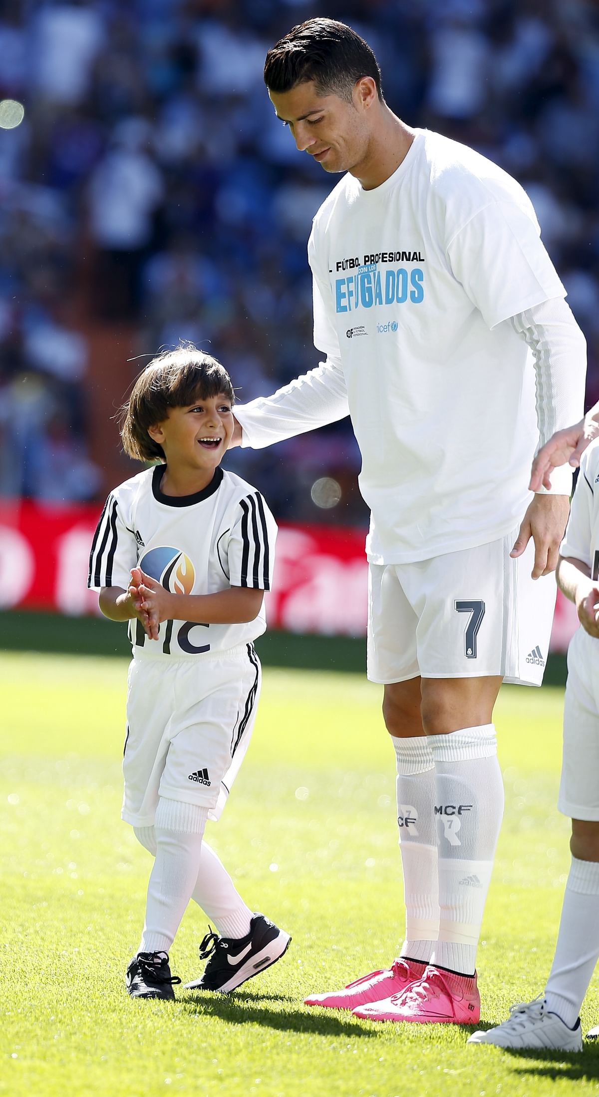 The Syrian father and his son who were tripped by the journo were Real Madrid’s special guests on Saturday.
