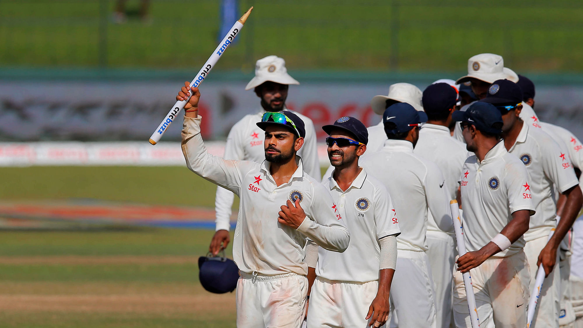 India’s captain Virat Kohli, foreground, holds a stump as he leads his team off the pitch after defeating Sri Lanka in their third test. (Photo: AP)