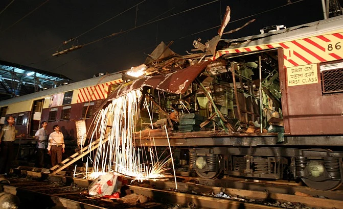 Workers cut a damaged part of the local train compartment hit by the blast. (Photo: Reuters)