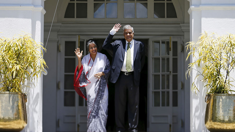 Ranil Wickremesinghe (R), leader of Sri Lanka’s United National Party (UNP), waves next to his wife Maitree Wickremesinghe at the PM’s official residence in Colombo. (Photo: Reuters)