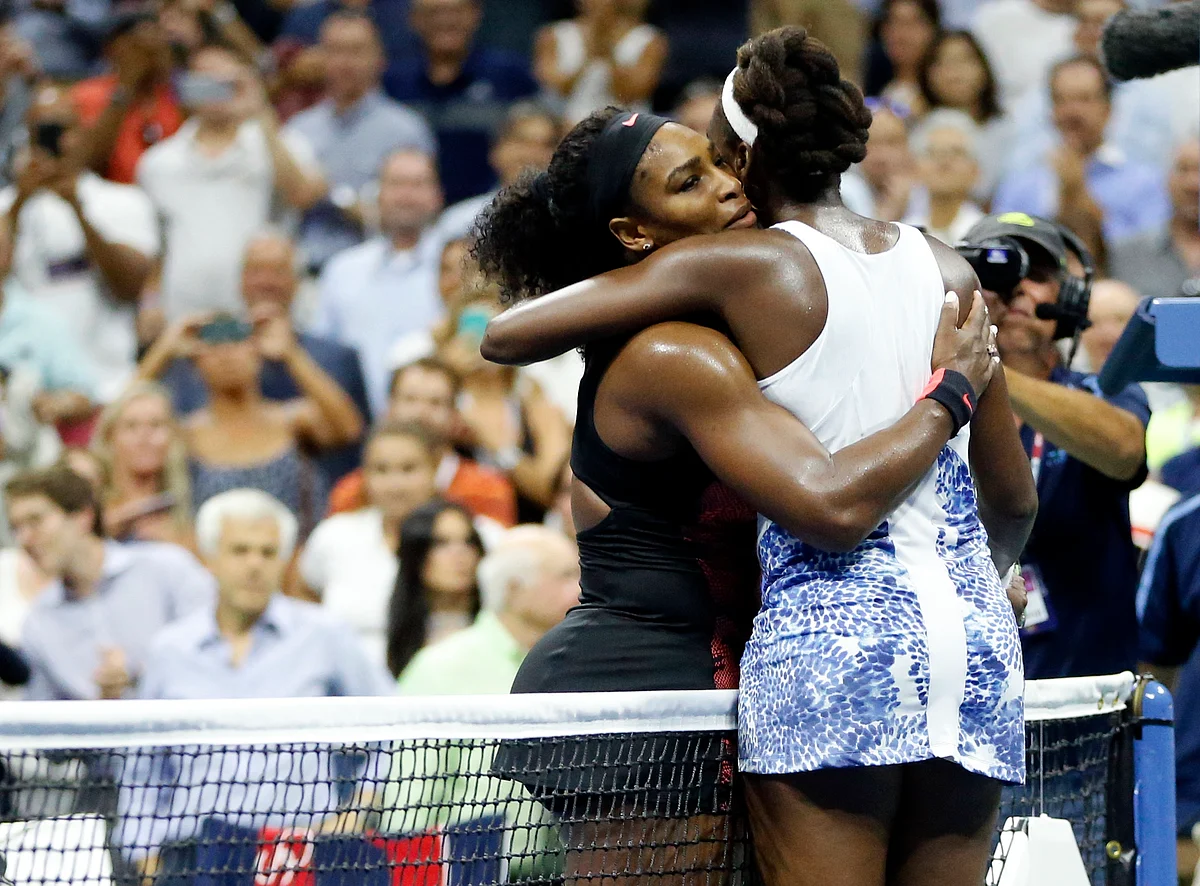 Serena Williams and Venus Williams hug each other after their quarter-final in the US Open on Tuesday. (Photo: AP)
