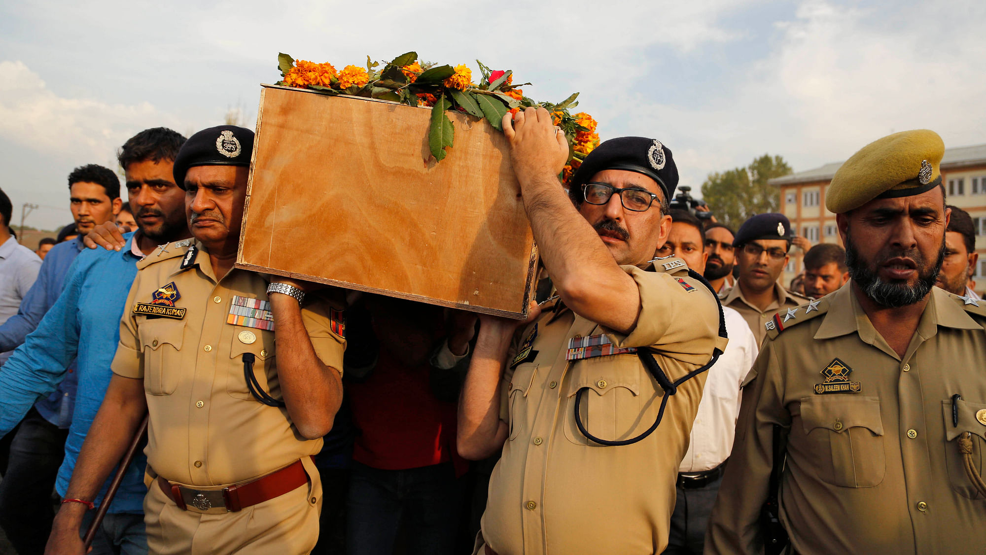 Police officers carry the coffin of their colleague Altaf Ahmed during the wreath-laying ceremony in Srinagar. (Photo: AP)
