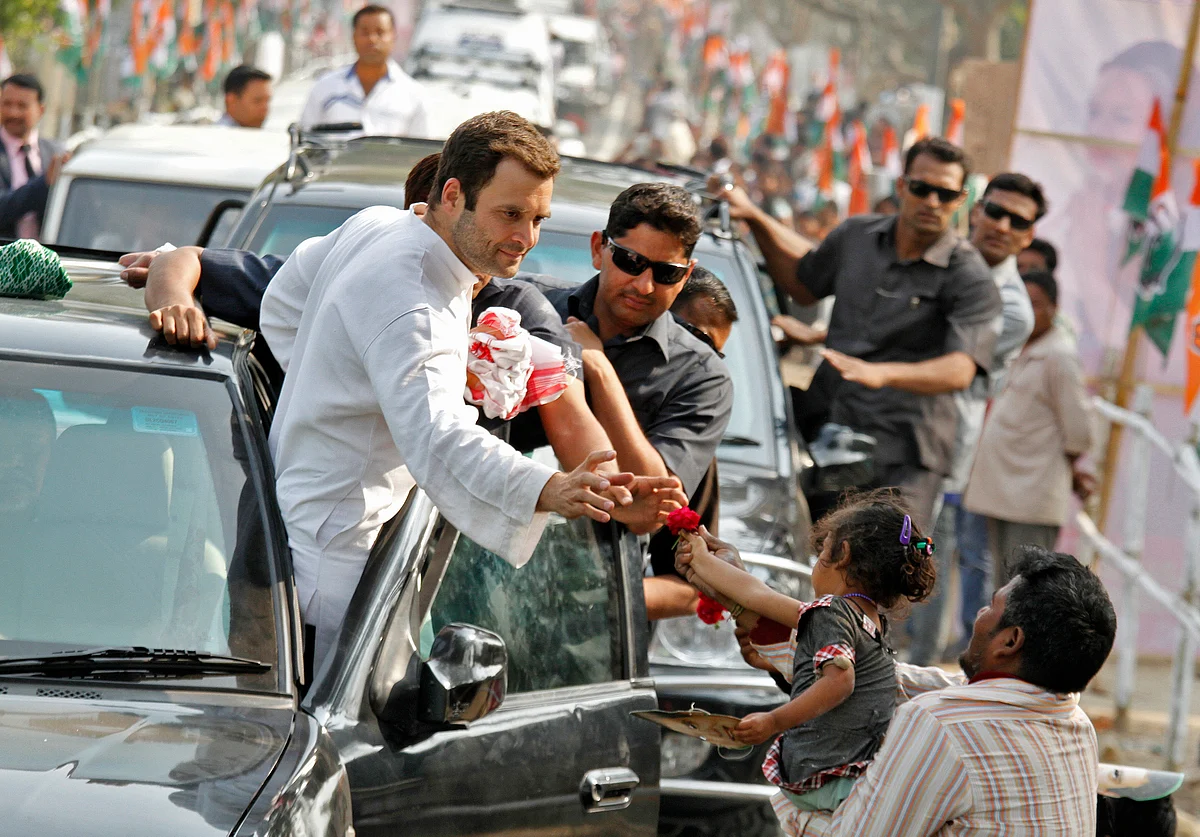 Rahul Gandhi Congress Vice President and son of party chief Sonia Gandhi, receives a flower from a child during a road show ahead of the 2014 general elections. (Photo: Reuters)