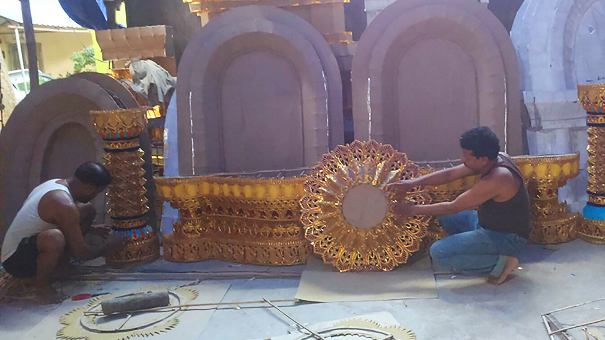 Artisans fixing tableaux with decorative pieces for Durga Puja. (Photo: Bhakta B Rath)