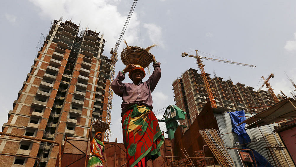 Labourers work at the construction site of a residential complex in Noida on the outskirts of New Delhi. (Photo: Reuters) 