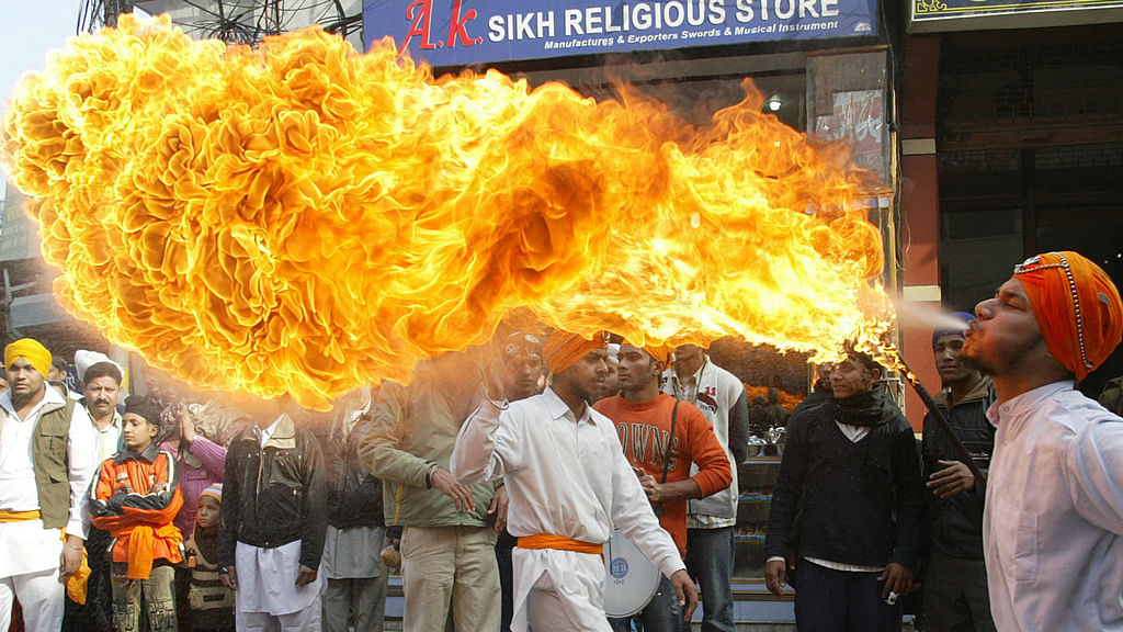 <p>A file photo of a Sikh fire breather performs during a religious procession ahead of the birth anniversary of Guru Gobind Singh in Amritsar.</p>