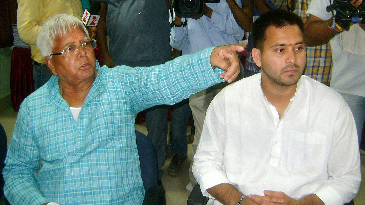 RJD chief Lalu Prasad during filing of nomination papers by his son and party candidate from Raghopur Tejashwi Yadav (R) in Hajipur, October 3, 2015. (Photo: PTI)