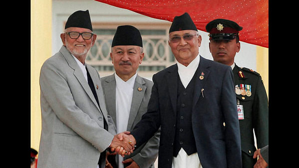 Nepal’s newly elected PM Khadga Prasad Oli and former PM Sushil Koirala shake hands. (Photo: PTI)