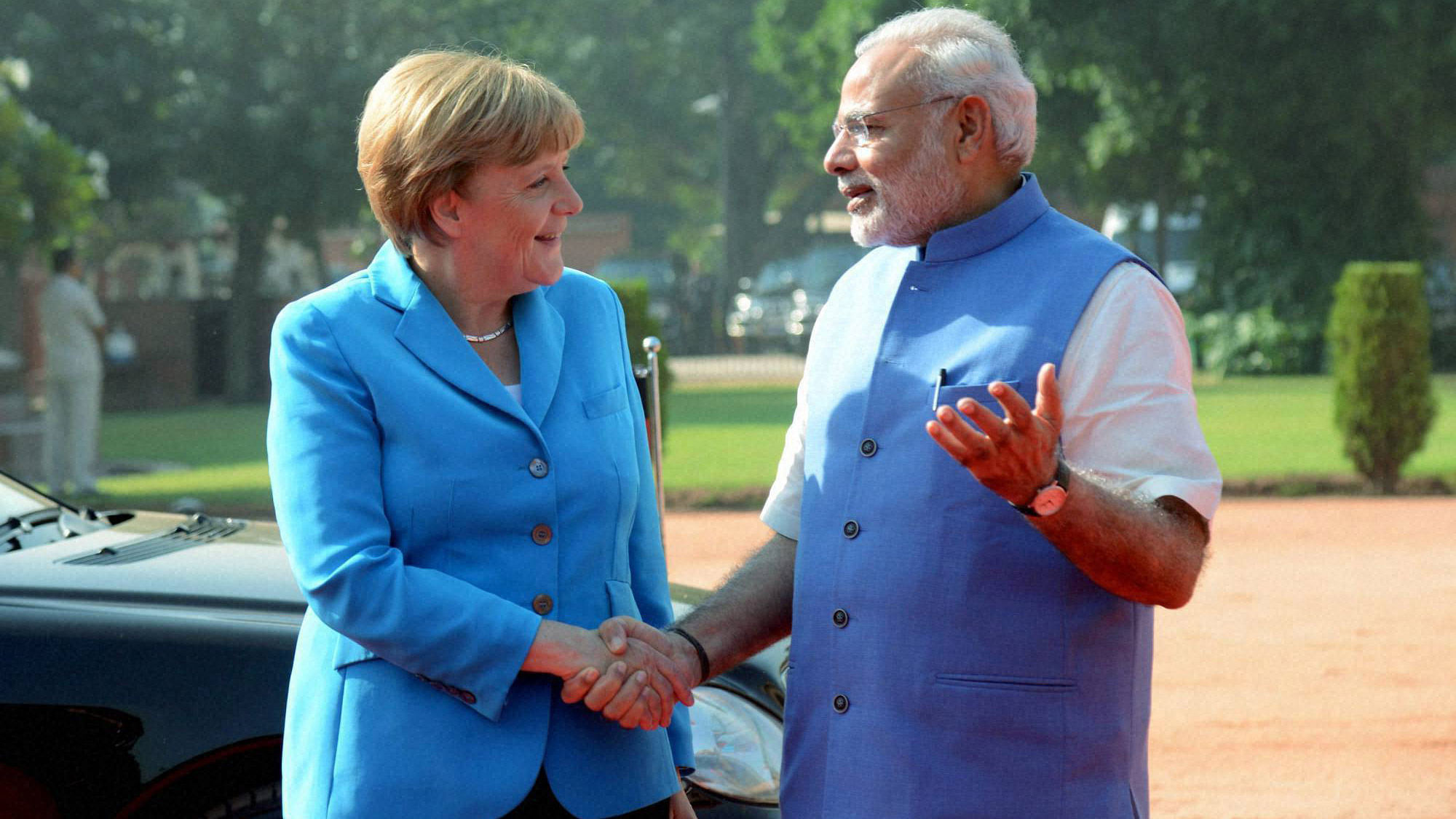 Prime Minister Narendra Modi with German Chancellor Angela Merkel during the ceremonial reception at the forecourt of Rashtrapati Bhawan in New Delhi on Monday. (Photo: PTI)