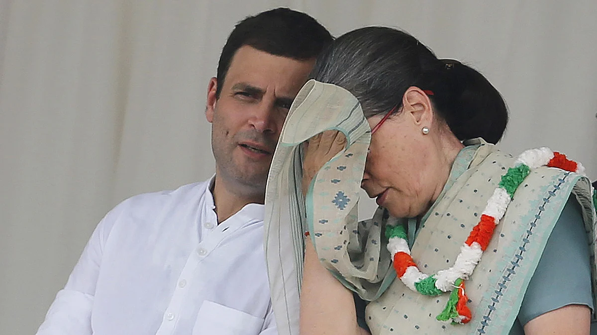 Congress party Vice President Rahul Gandhi speaks to his mother Sonia at a rally in New Delhi. (Photo: Reuters)