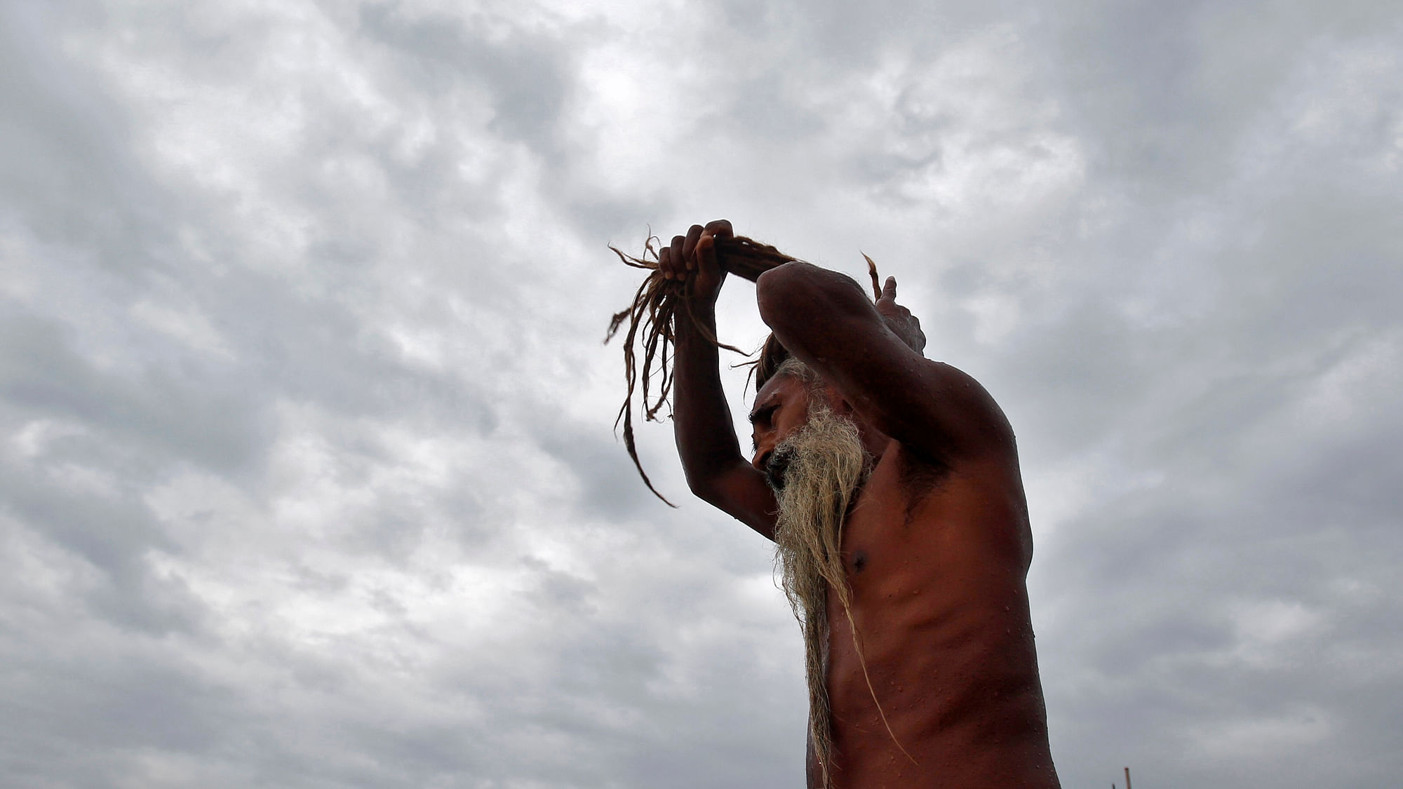  A sadhu adjusts his dreadlocks after taking a holy dip in the waters of Sangam in&nbsp; Allahabad. (Photo: Reuters) 