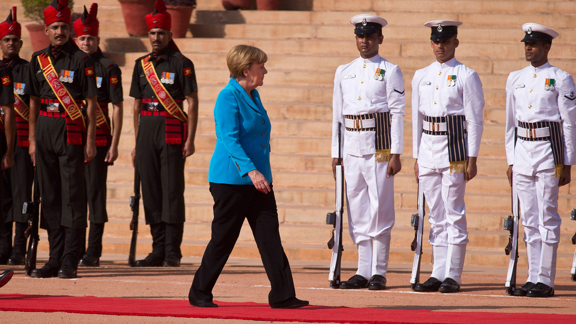 German Chancellor Angela Merkel reviews the guard of honour during the ceremonial reception at Rashtrapati Bhavan. (Photo: AP)