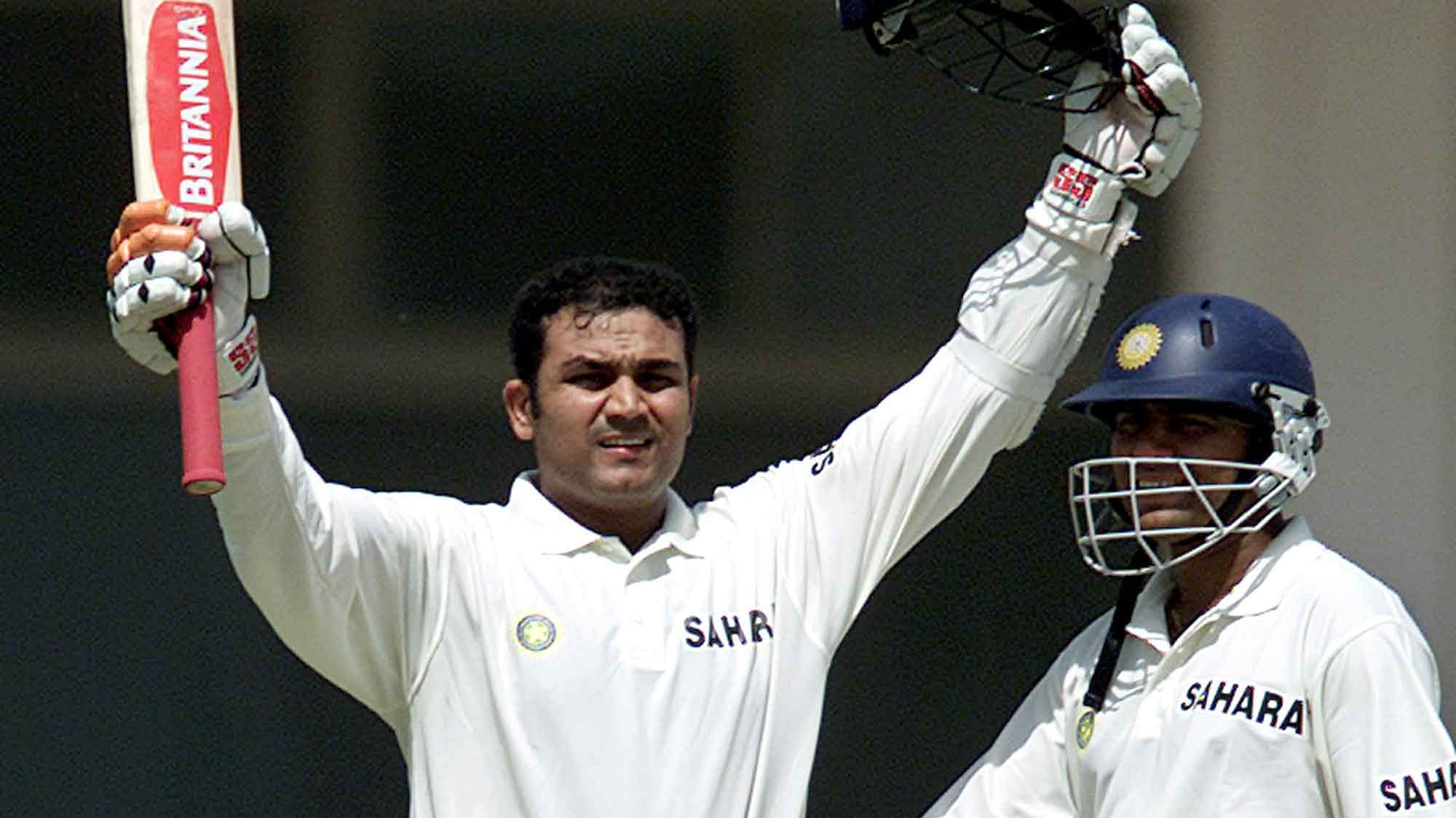  Virender Sehwag celebrates a century as Aakash Chopra watches on, during the Multan test against Pakistan on March 28, 2004. (Photo: Reuters)