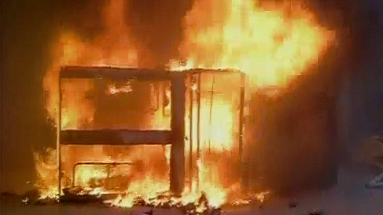 Police van burnt by angry protesters. (Photo: ANI screengrabs)