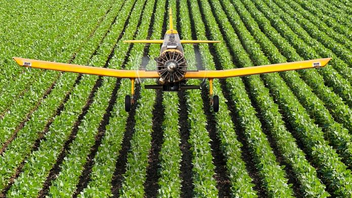 Crop Duster Aircraft spraying crops with aerial application. (Photo: iStockphoto)
