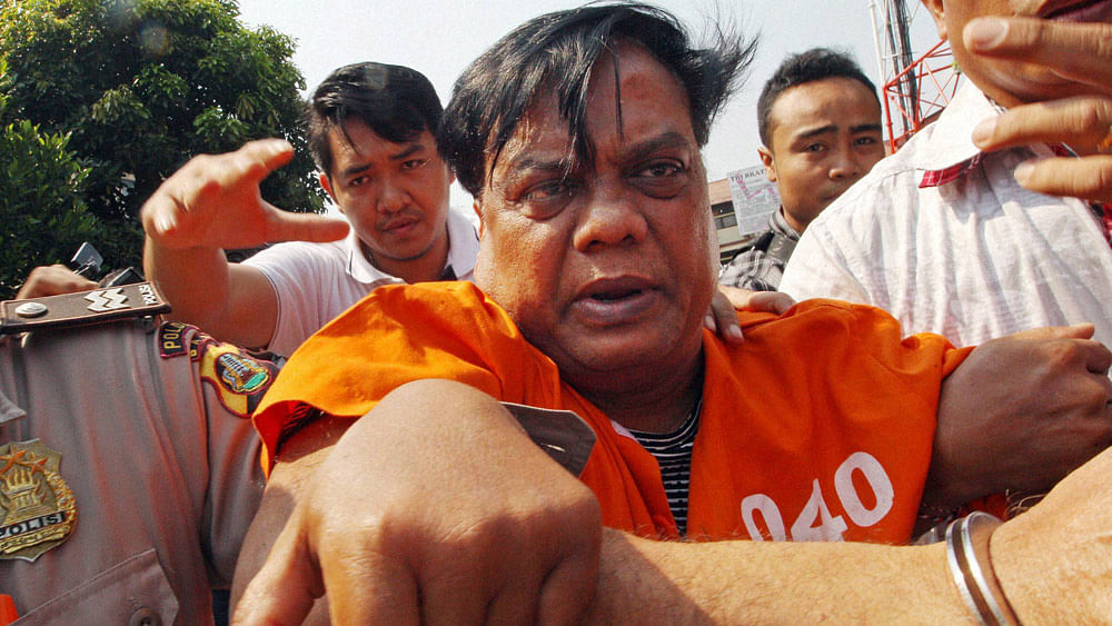 Chhota Rajan (centre) being escorted by plain-clothed police officers for questioning in Bali, Indonesia, Thursday, 29 October 2015. (Photo: PTI)