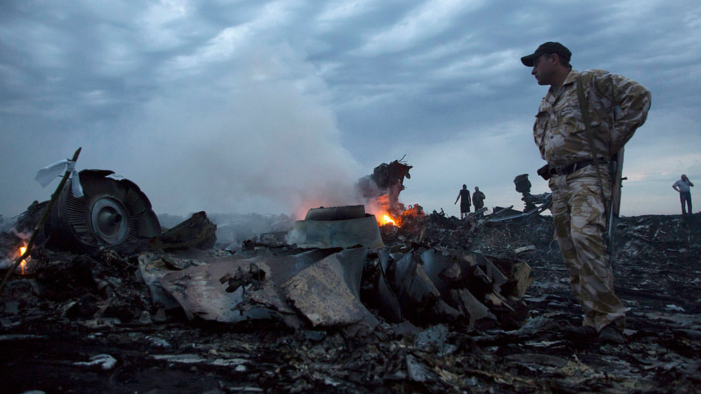  File photo of people walking amongst the debris, at the crash site of a passenger plane near the village of Grabovo, Ukraine.&nbsp;