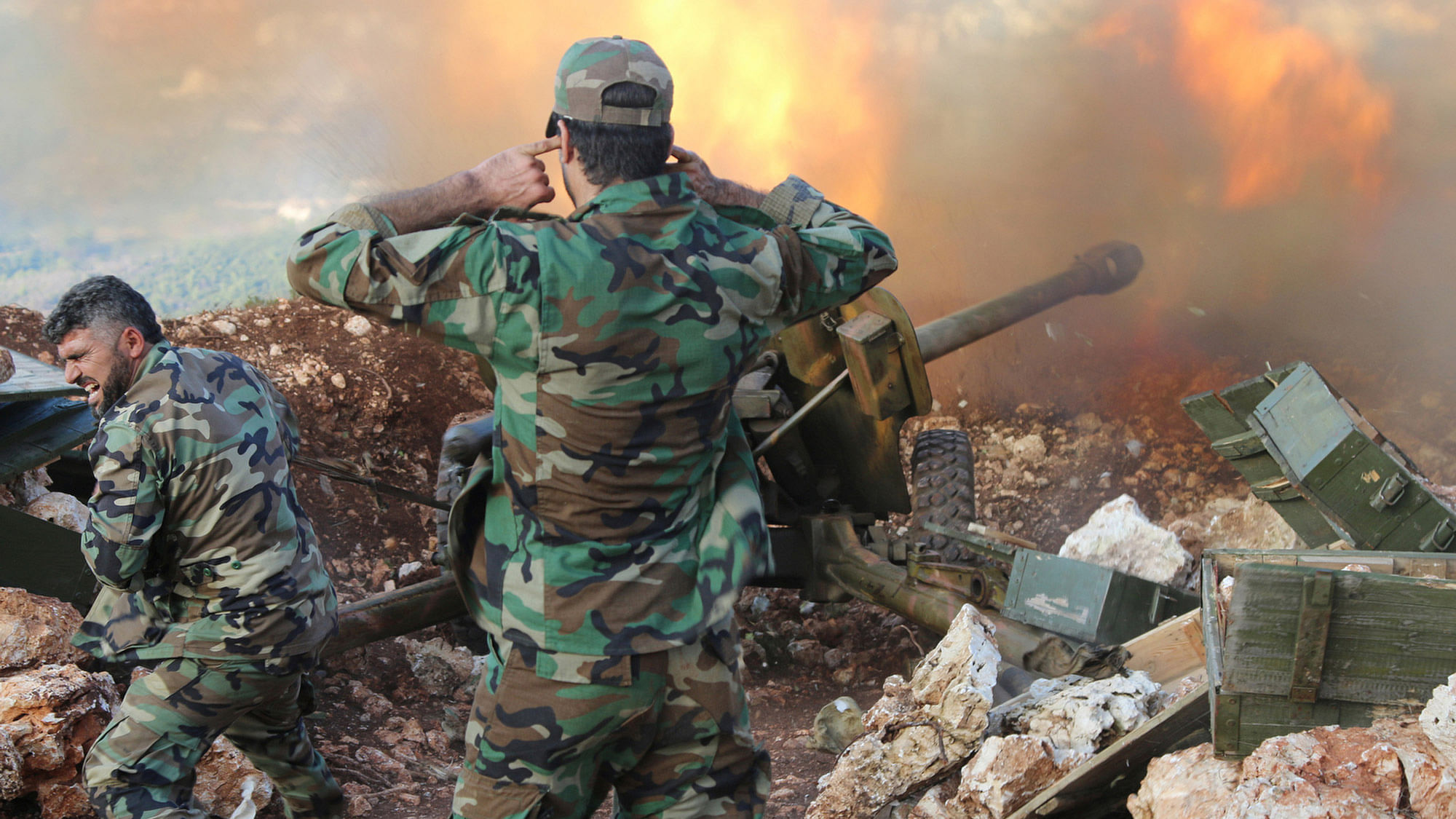 In this photo taken on Saturday, October 10, 2015, Syrian soldiers  fire a cannon in Lattakia province,  in Syria. Backed by Russian air strikes, the Syrian army has launched an offensive in central and northwestern regions of the country. (Photo: AP)