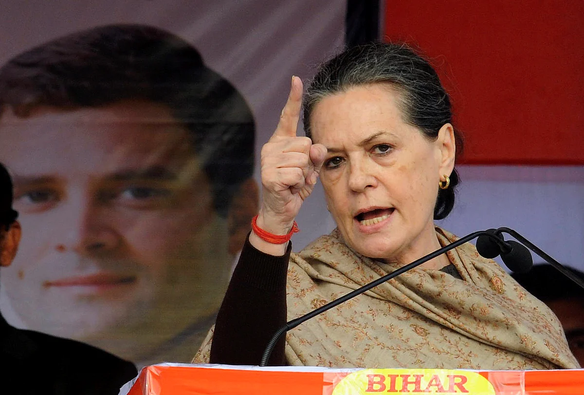 Sonia Gandhi addresses a gathering next to a portrait of her son and Congress Vice President Rahul Gandhi in Bihar. (Photo: Reuters)