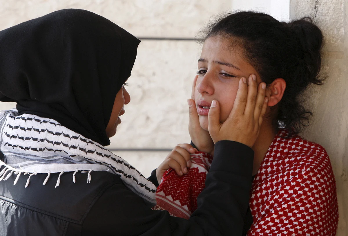A relative of 27-year-old Palestinian Mutaz Zawahereh, who was killed by Israeli troops during clashes on Tuesday, is comforted as she mourns during his funeral in the West Bank city of Bethlehem (Photo: Reuters)