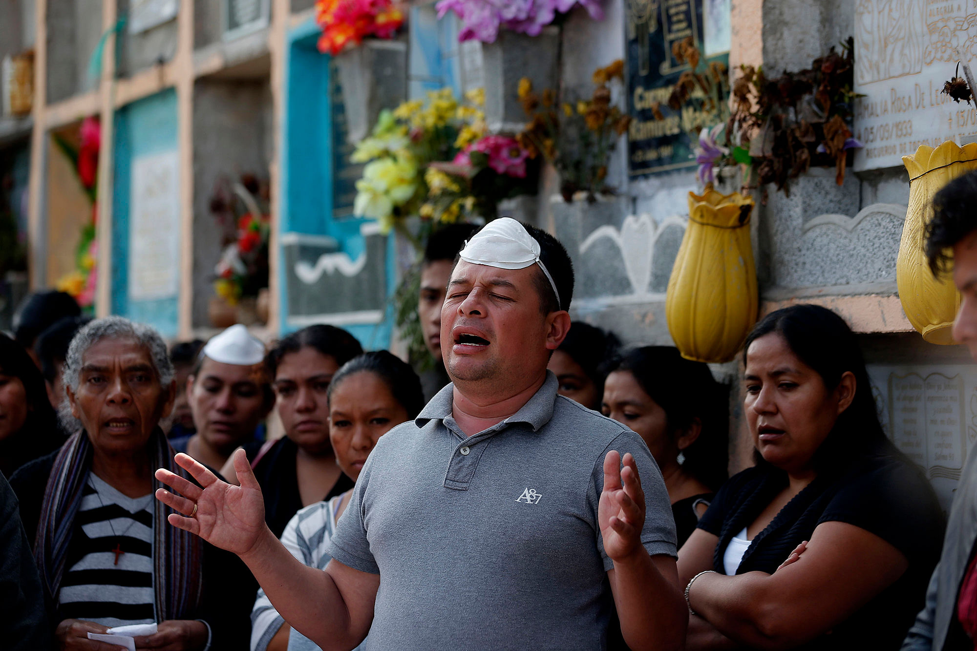 A man prays during the burial of mudslide victims in Guatemala City. (Photo: AP)<a></a>