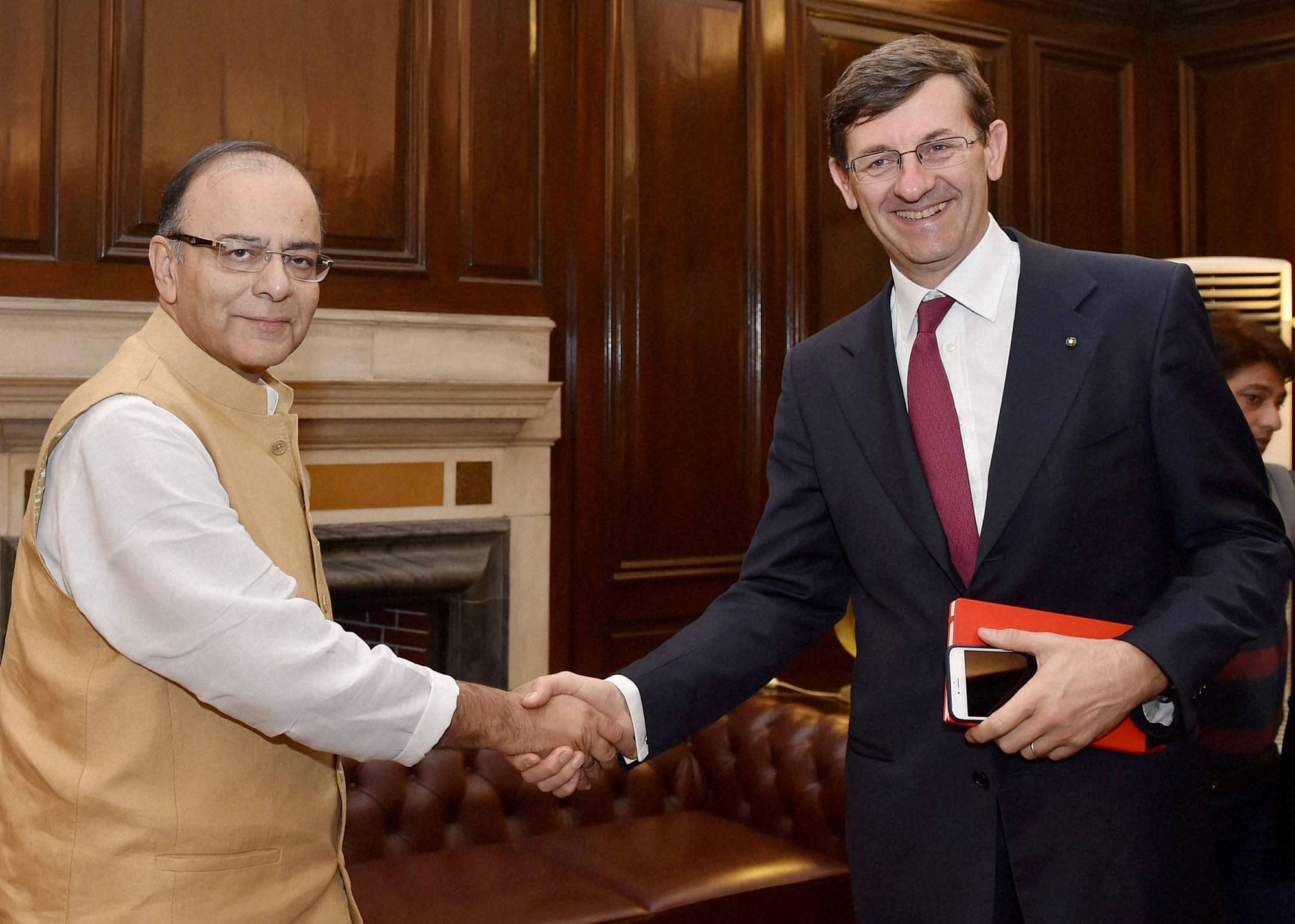 Union Minister for Finance, Corporate Affairs and Information &amp; Broadcasting, Arun Jaitley shakes hand with Vodafone Group CEO Vittorio Colao during a meeting in New Delhi. (Photo: PTI) 