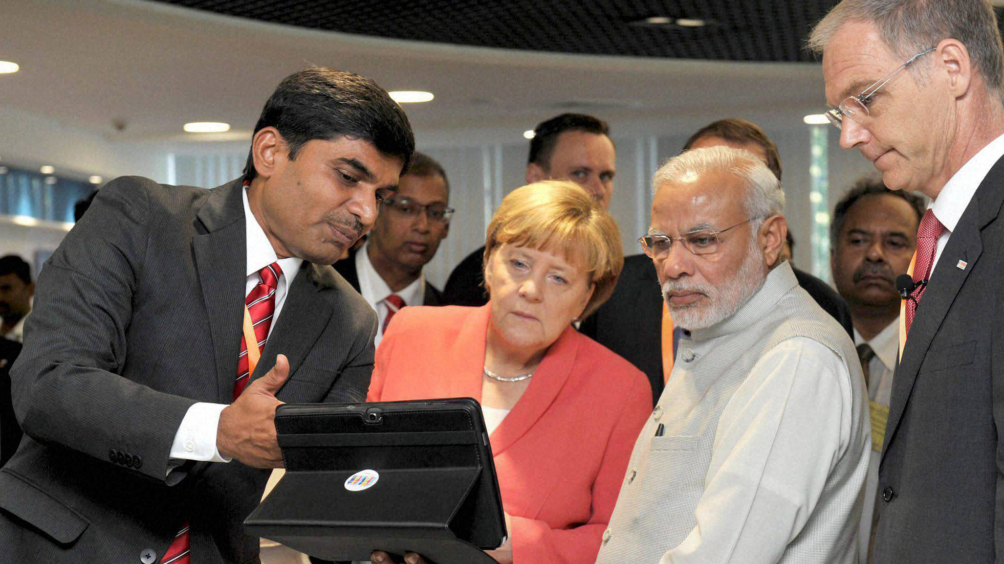 Prime Minister Narendra Modi and German Chancellor Angela Merkel during their visit to Robert Bosch Engineering &amp; Innovation Centre in Bengaluru on Tuesday.&nbsp;(Photo: PTI)
